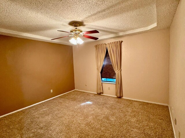 empty room with a textured ceiling, carpet floors, and ceiling fan