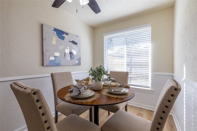 dining space with hardwood / wood-style floors, a textured ceiling, a wealth of natural light, and ceiling fan