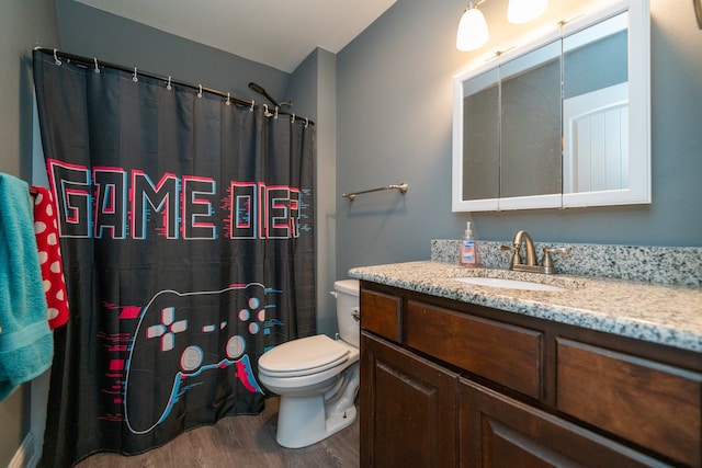 bathroom featuring vanity, hardwood / wood-style flooring, toilet, and curtained shower