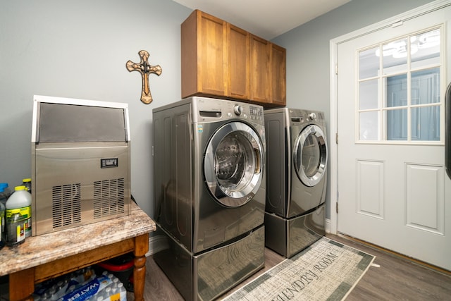 laundry area featuring cabinets, dark wood-type flooring, and washing machine and dryer