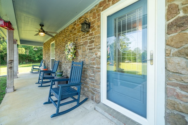 entrance to property with ceiling fan and a porch