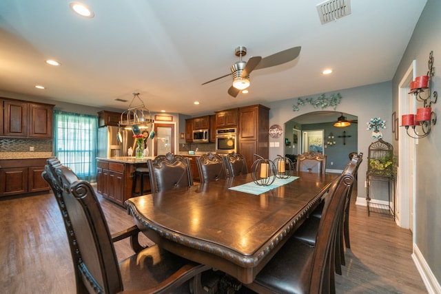 dining area with dark hardwood / wood-style floors and ceiling fan