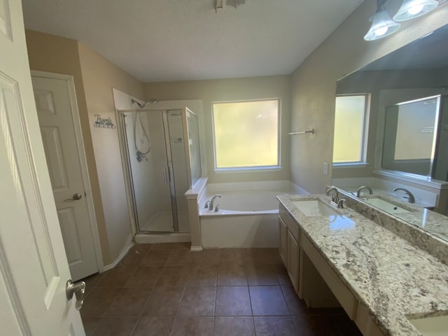 bathroom featuring shower with separate bathtub, vanity, and tile patterned floors