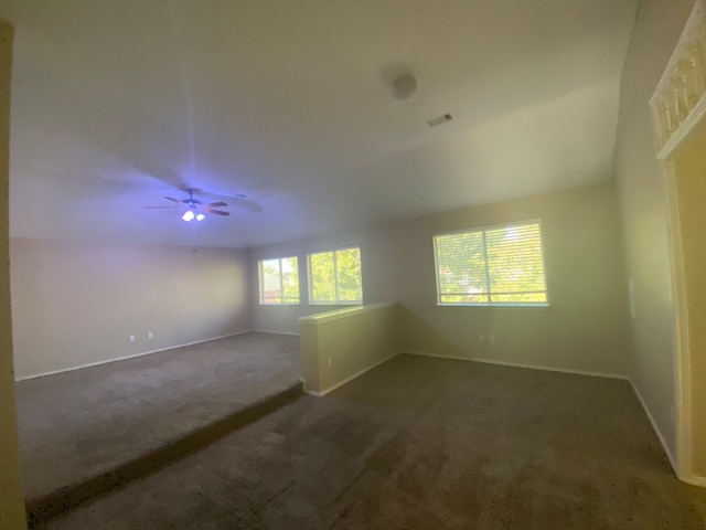 carpeted empty room featuring ceiling fan and lofted ceiling