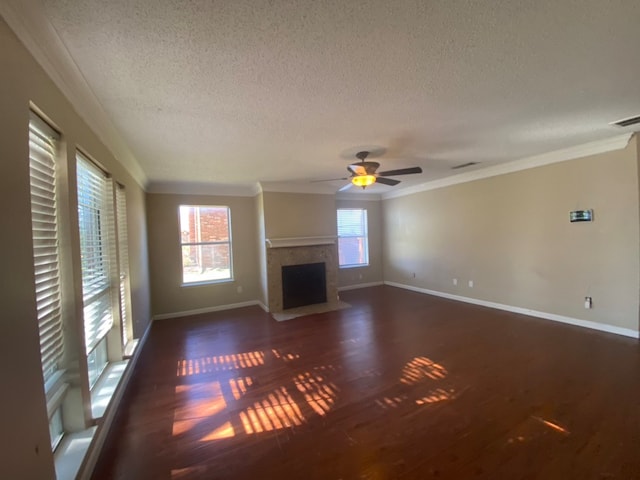 unfurnished living room with a textured ceiling, ceiling fan, dark hardwood / wood-style flooring, and crown molding