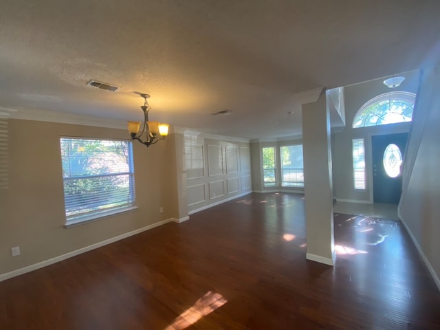 entryway featuring a notable chandelier and dark wood-type flooring