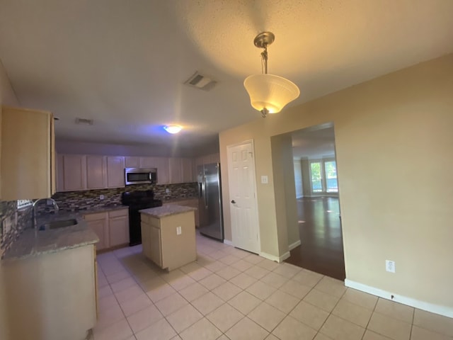 kitchen with a center island, sink, stainless steel appliances, backsplash, and pendant lighting