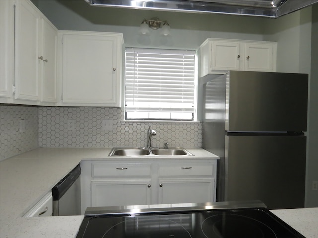 kitchen with appliances with stainless steel finishes, tasteful backsplash, and white cabinetry