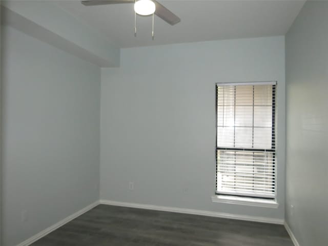 spare room featuring ceiling fan and dark wood-type flooring