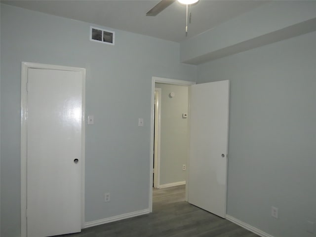 empty room featuring dark hardwood / wood-style flooring and ceiling fan