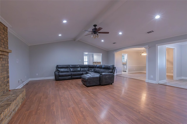 living room with lofted ceiling with beams, ceiling fan, wood-type flooring, and ornamental molding