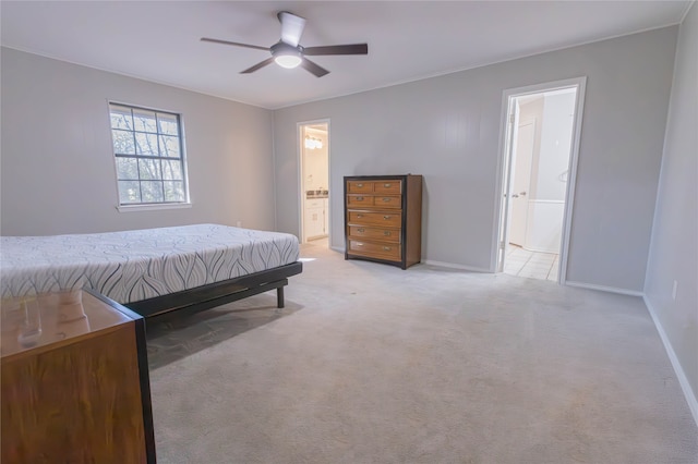 carpeted bedroom featuring ensuite bathroom and ceiling fan