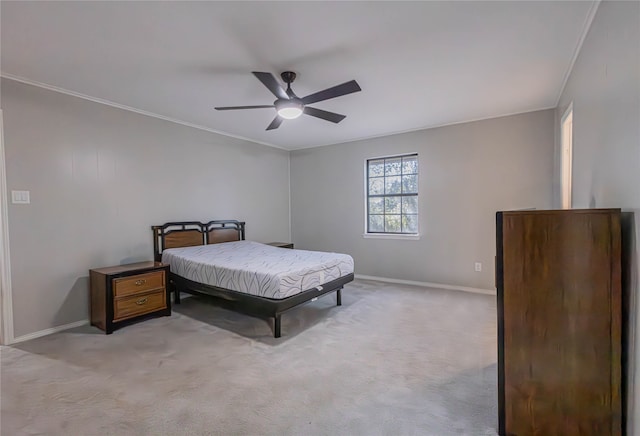 carpeted bedroom with ceiling fan and ornamental molding