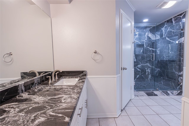 bathroom featuring tile patterned flooring, vanity, and walk in shower