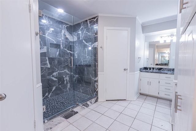 bathroom with tile patterned floors, vanity, an enclosed shower, and ornamental molding