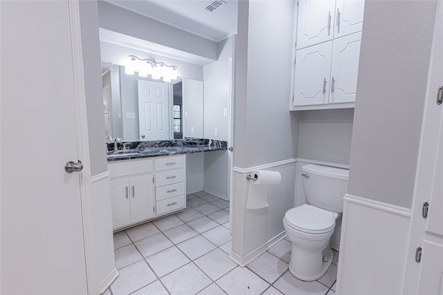 bathroom featuring tile patterned flooring, vanity, and toilet