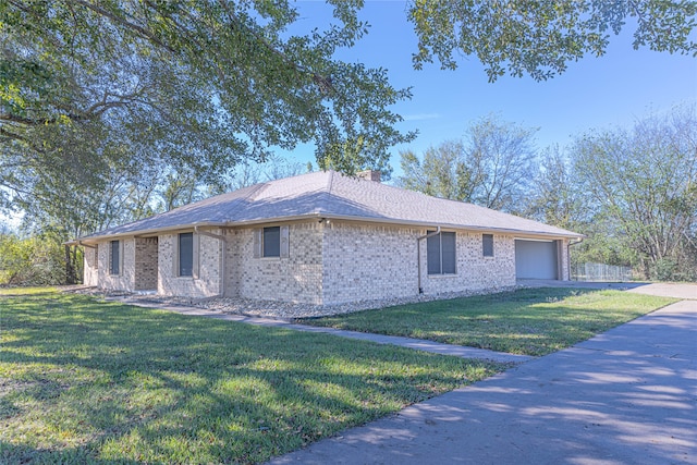 view of property exterior with a yard and a garage