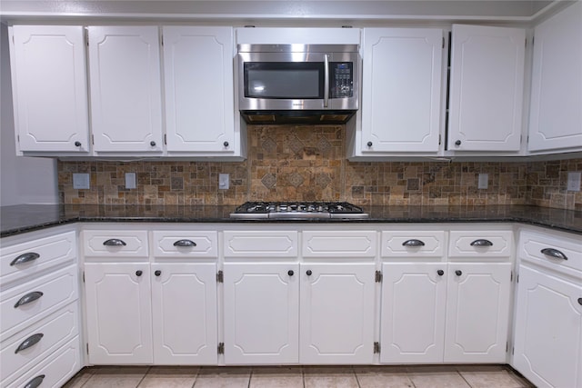 kitchen featuring backsplash, white cabinetry, and stainless steel appliances