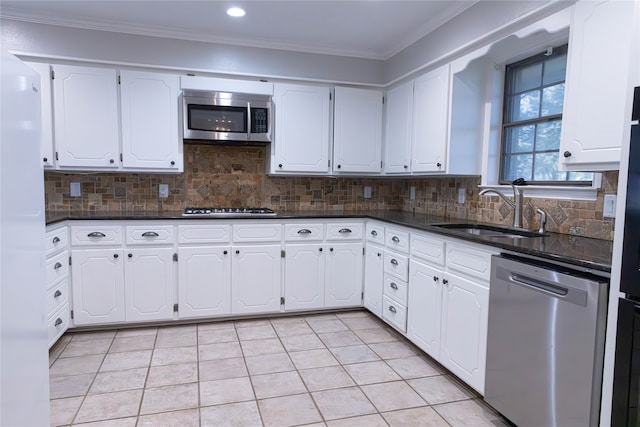 kitchen with white cabinetry, sink, tasteful backsplash, appliances with stainless steel finishes, and ornamental molding