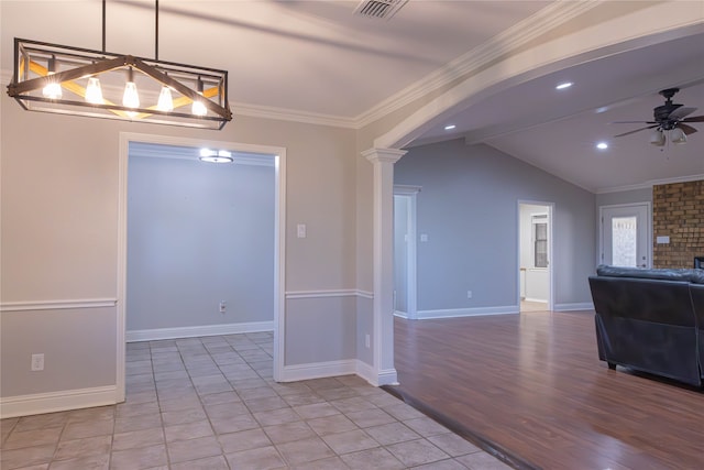 unfurnished dining area with ceiling fan, light hardwood / wood-style flooring, decorative columns, crown molding, and lofted ceiling