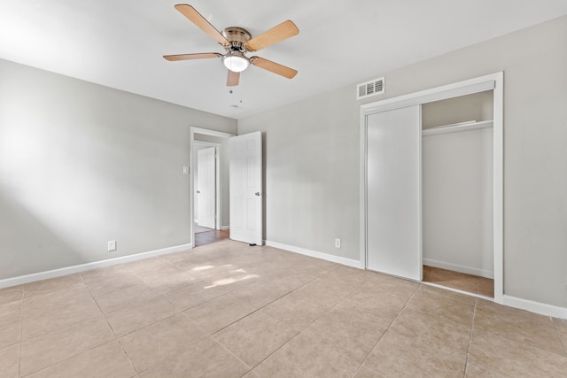 unfurnished bedroom with a closet, ceiling fan, and light tile patterned floors