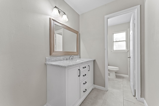 half bath with baseboards, vanity, toilet, and tile patterned floors