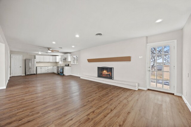 kitchen with white cabinetry, ceiling fan, decorative backsplash, a wealth of natural light, and appliances with stainless steel finishes