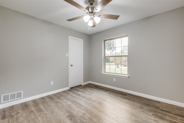 spare room featuring light hardwood / wood-style flooring and ceiling fan