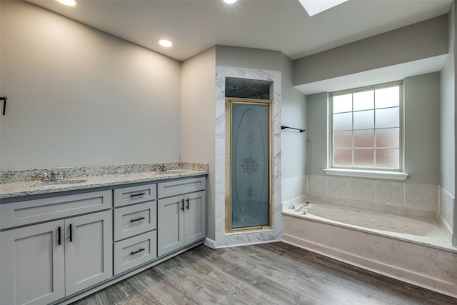 bathroom featuring hardwood / wood-style floors, vanity, and independent shower and bath