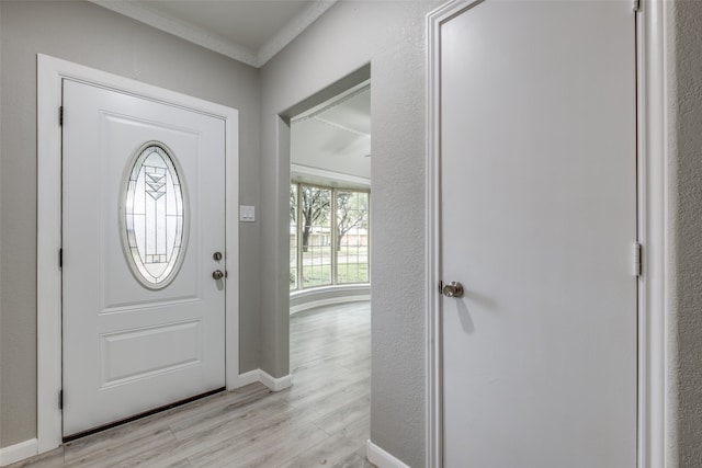 entryway featuring light hardwood / wood-style flooring and ornamental molding