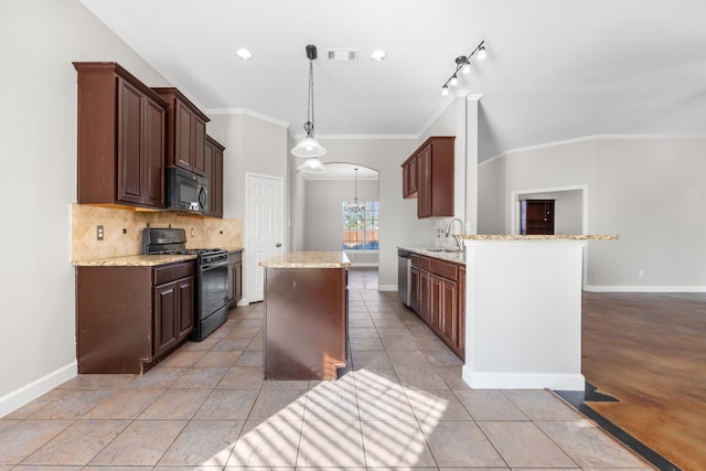 kitchen with crown molding, pendant lighting, decorative backsplash, light tile patterned floors, and black appliances