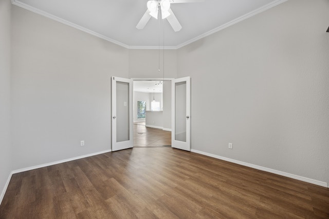 spare room with french doors, dark hardwood / wood-style flooring, ceiling fan, and ornamental molding