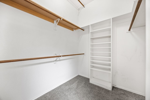 spacious closet featuring dark carpet