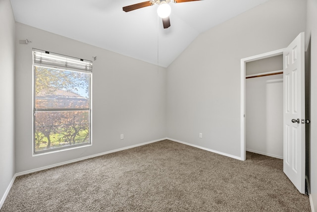 unfurnished bedroom with ceiling fan, a closet, carpet floors, and vaulted ceiling