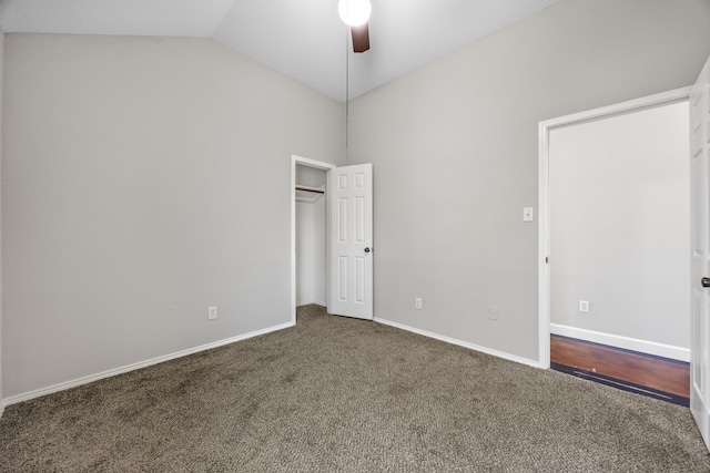 unfurnished bedroom with carpet, ceiling fan, and vaulted ceiling