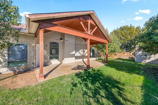 back of house with a lawn, ceiling fan, and a patio area