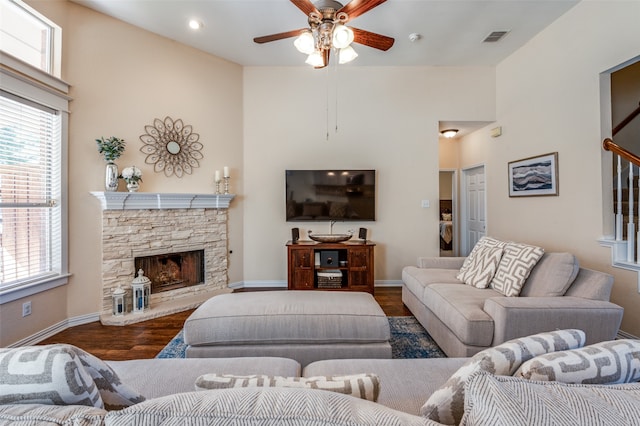 living room with ceiling fan, a fireplace, and dark hardwood / wood-style floors