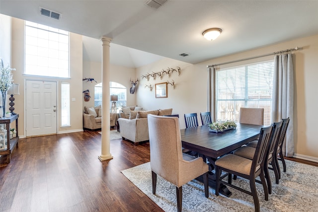 dining area featuring dark hardwood / wood-style floors and ornate columns