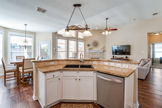 kitchen featuring sink, dark hardwood / wood-style flooring, stainless steel dishwasher, a kitchen island with sink, and white cabinets