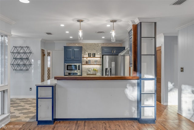 kitchen featuring appliances with stainless steel finishes, ornamental molding, blue cabinets, pendant lighting, and light hardwood / wood-style flooring