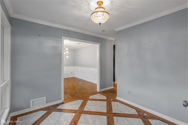 unfurnished room with ornamental molding and a notable chandelier