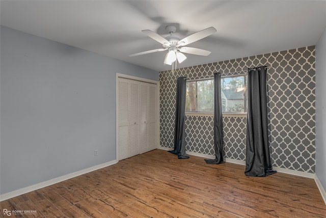 unfurnished bedroom with ceiling fan, a closet, and light wood-type flooring