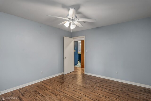 empty room with hardwood / wood-style flooring and ceiling fan