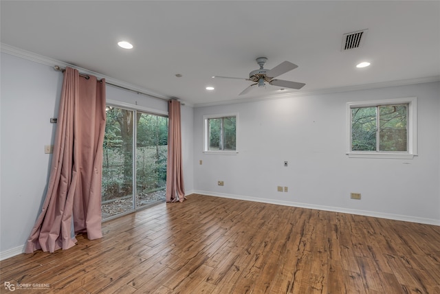 spare room featuring hardwood / wood-style flooring, plenty of natural light, and ornamental molding