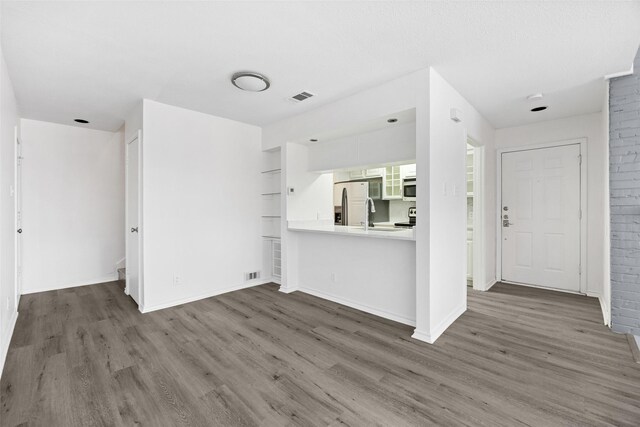 unfurnished living room with lofted ceiling, a fireplace, and dark hardwood / wood-style floors