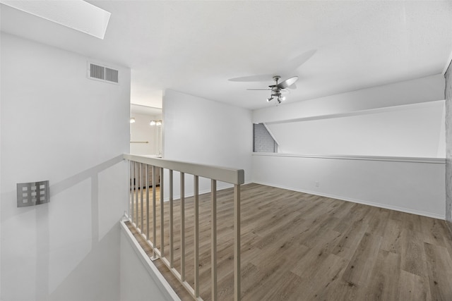 interior space featuring a skylight and wood-type flooring