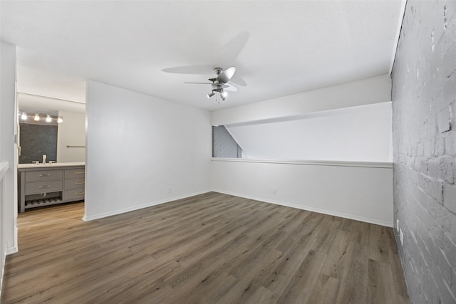 empty room featuring ceiling fan and dark wood-type flooring