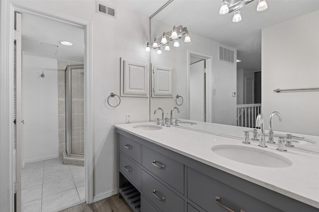 bathroom with tile patterned floors, vanity, and a shower with shower door