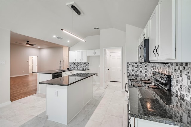 kitchen with vaulted ceiling, sink, black appliances, white cabinets, and a center island