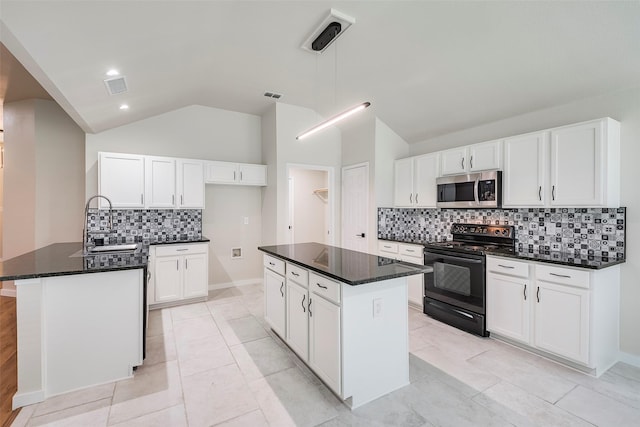 kitchen with white cabinetry, tasteful backsplash, black electric range, an island with sink, and lofted ceiling